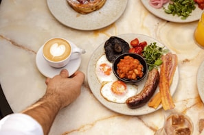 a hand holding a plate of food