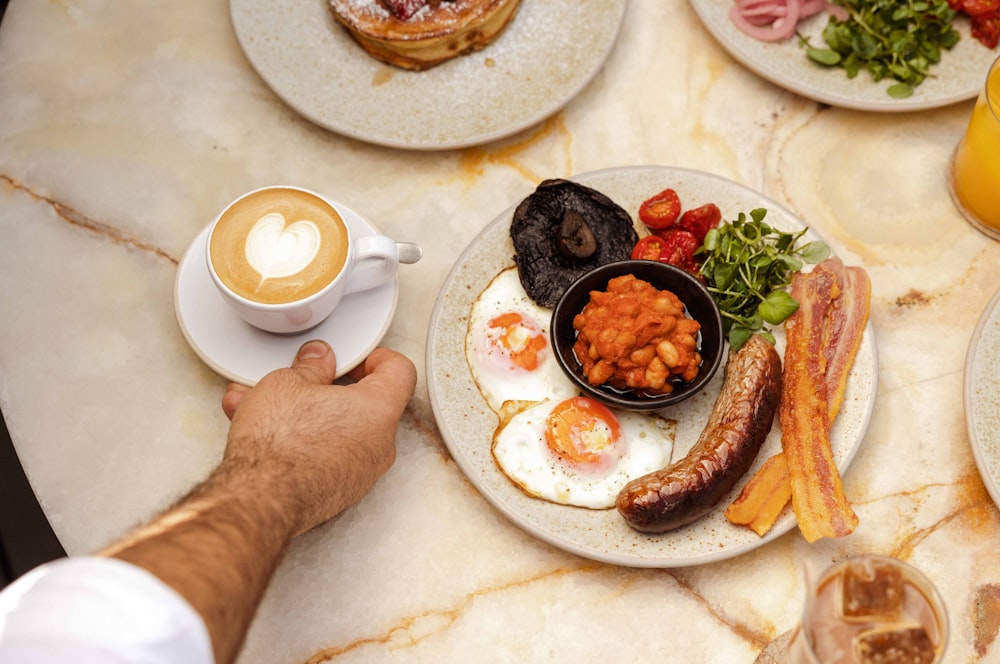 a hand holding a plate of food