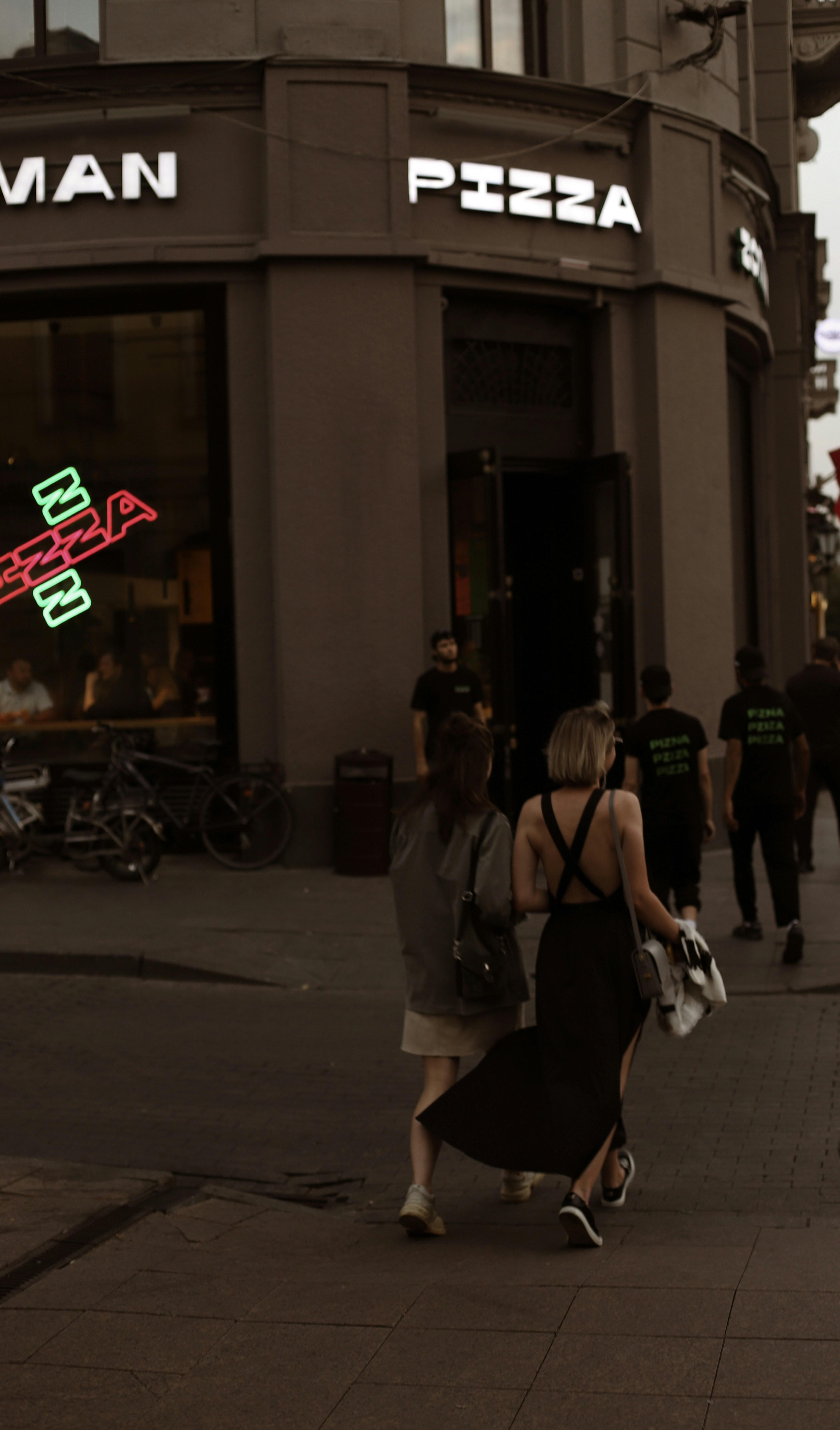 a couple of women walking down a sidewalk