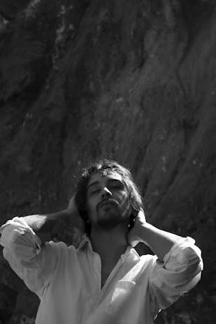 A lifestyle shot of a person enjoying a peaceful moment outdoors, dressed in Serenova’s therapy clothing.