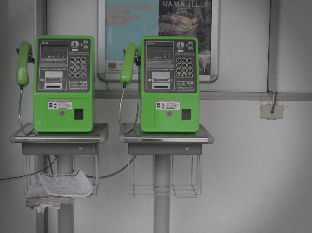 a green telephone on a table