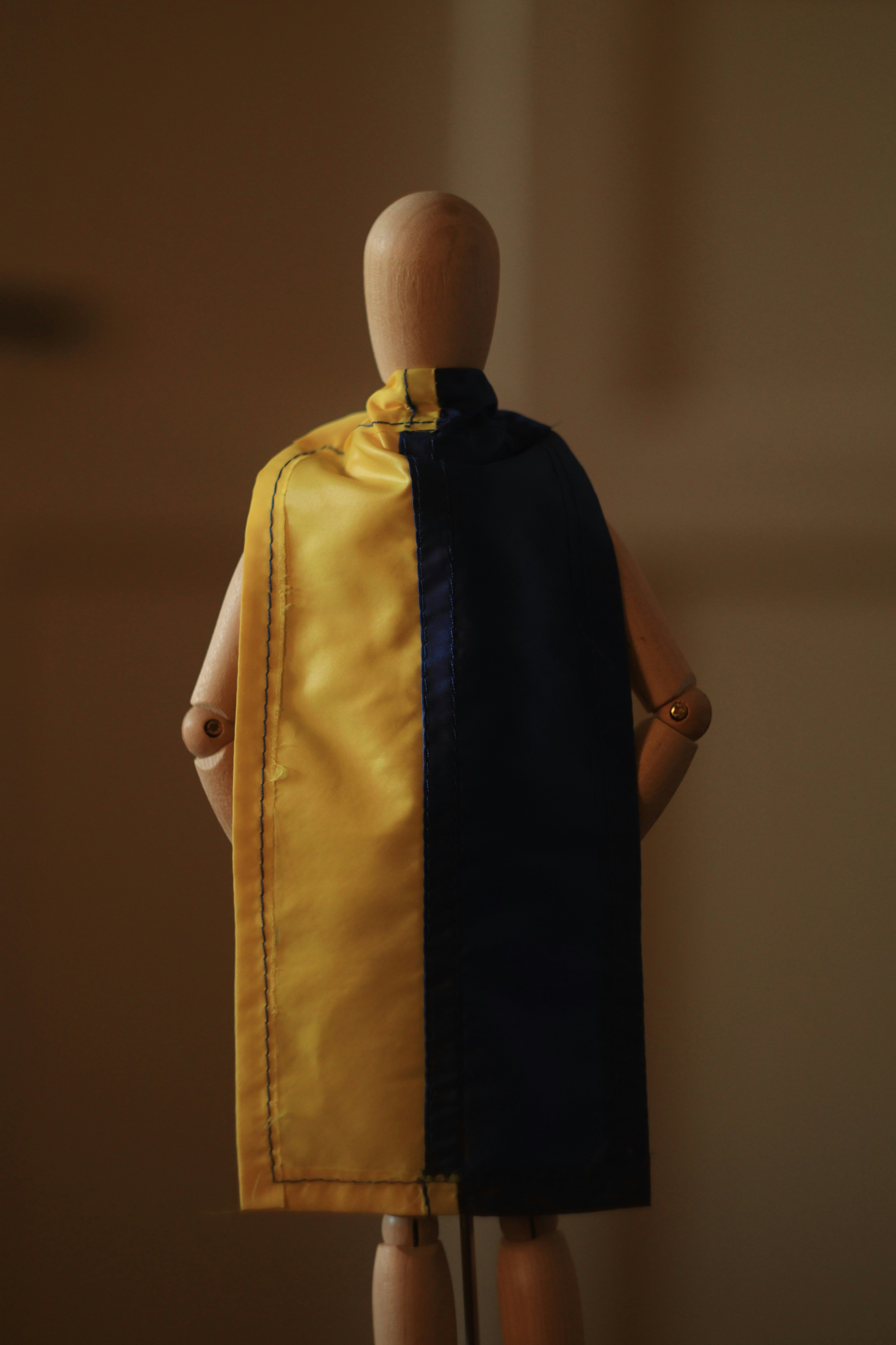 a mannequin wearing a yellow jacket and black shirt