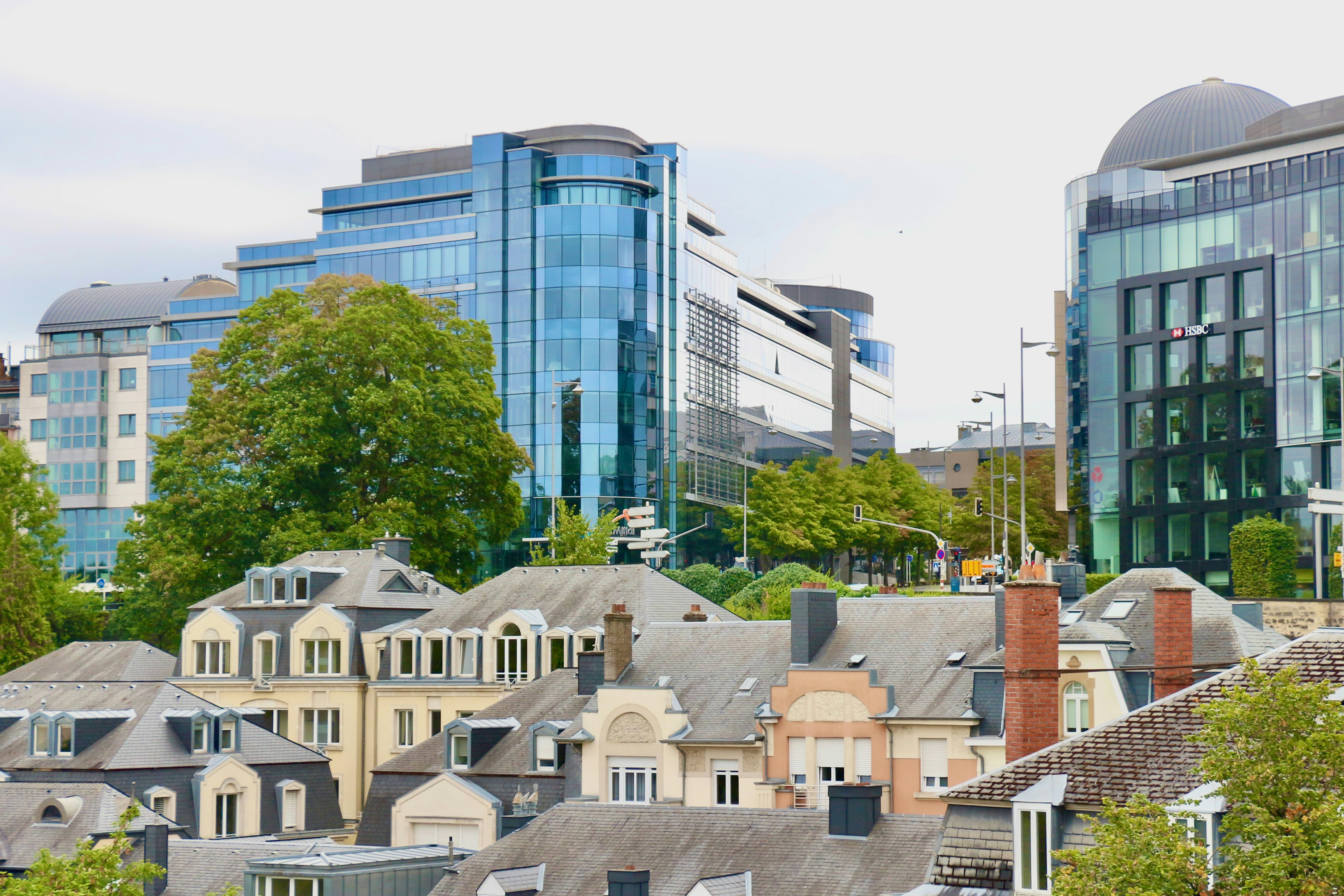 a group of buildings with trees in the front
