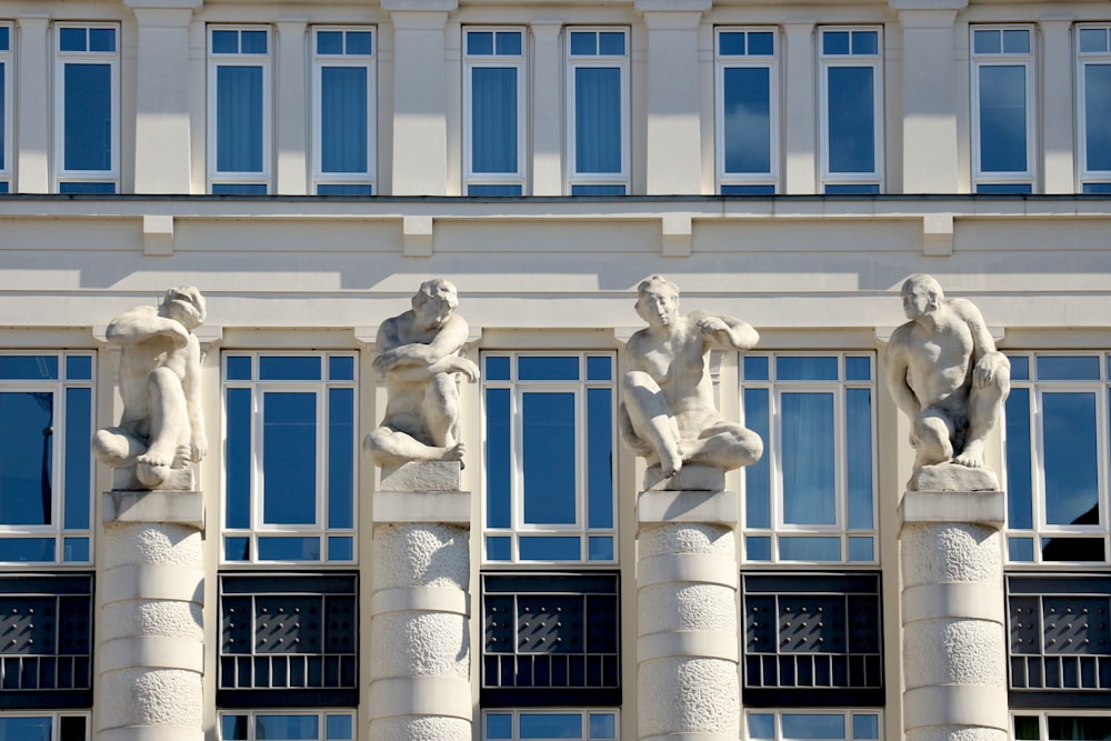 a group of statues in front of a building