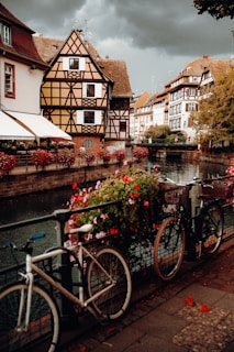 a row of bicycles parked on a bridge over a river