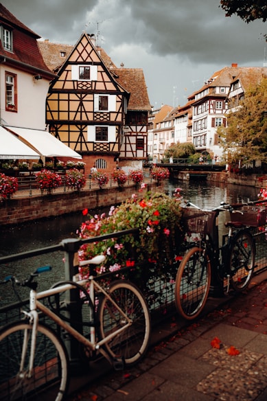 a row of bicycles parked on a bridge over a river