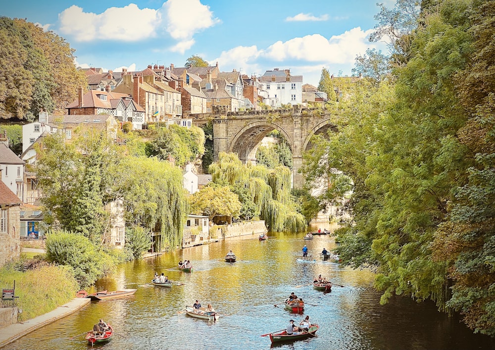 a river with boats and a bridge