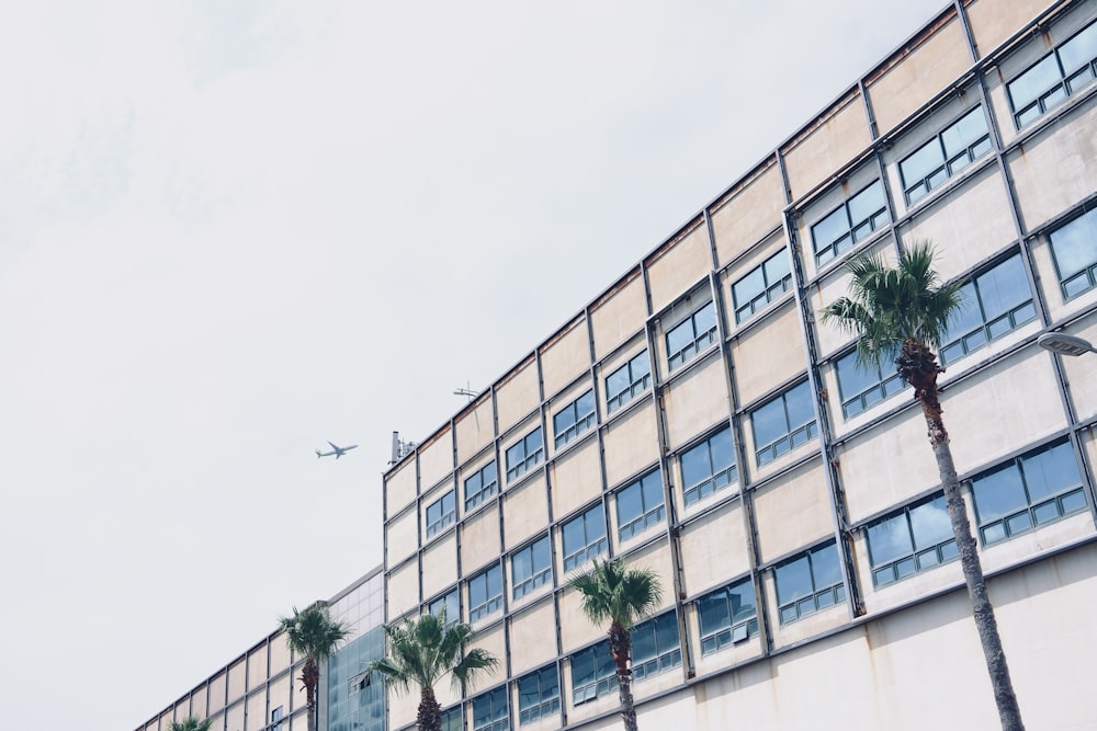 a plane flying over a building