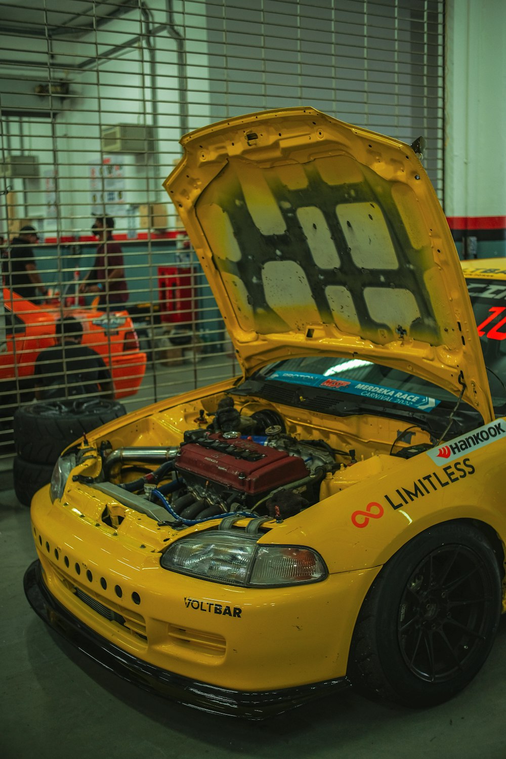 a yellow race car with a large helmet on top