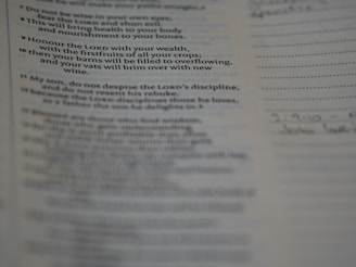 A close-up view of a printed page showcasing text from a book. The text seems to be a religious or inspirational passage. The image is focused on the words, with handwriting faintly visible on the right margin.