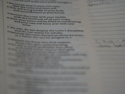 A close-up view of a printed page showcasing text from a book. The text seems to be a religious or inspirational passage. The image is focused on the words, with handwriting faintly visible on the right margin.