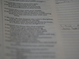 A close-up view of a printed page showcasing text from a book. The text seems to be a religious or inspirational passage. The image is focused on the words, with handwriting faintly visible on the right margin.