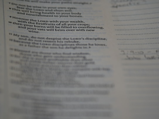 A close-up view of a printed page showcasing text from a book. The text seems to be a religious or inspirational passage. The image is focused on the words, with handwriting faintly visible on the right margin.