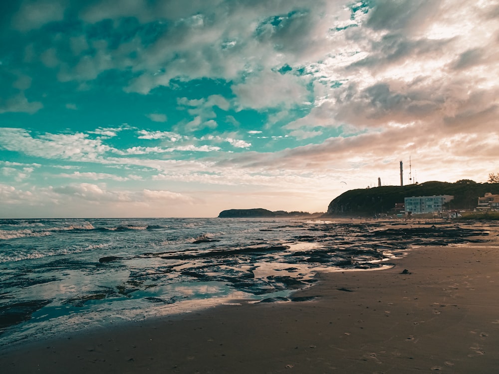 a beach with a building in the distance