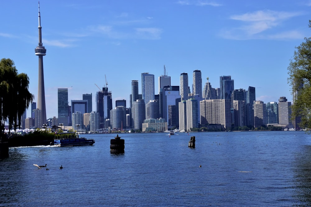 a city skyline with a body of water in front of it