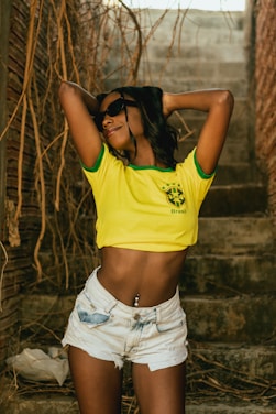 a person wearing a yellow shirt and sunglasses