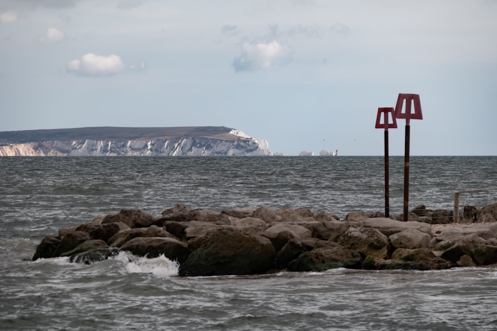 a rocky beach with a sign