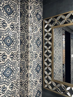 Patterned wall tiles in a bathroom creating a calm, sophisticated atmosphere.