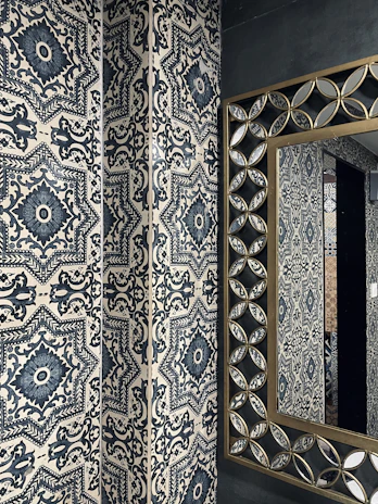 Patterned wall tiles in a bathroom creating a calm, sophisticated atmosphere.