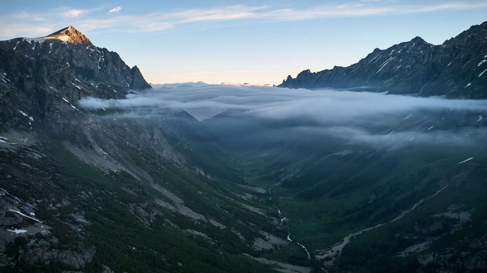 a valley with fog around it
