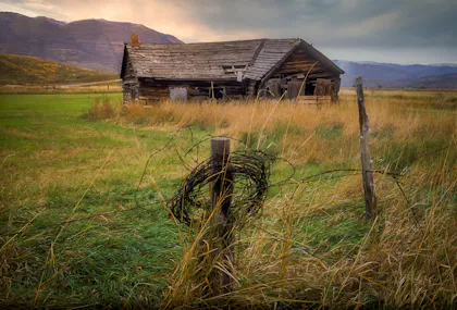Wooden farm building in an open field