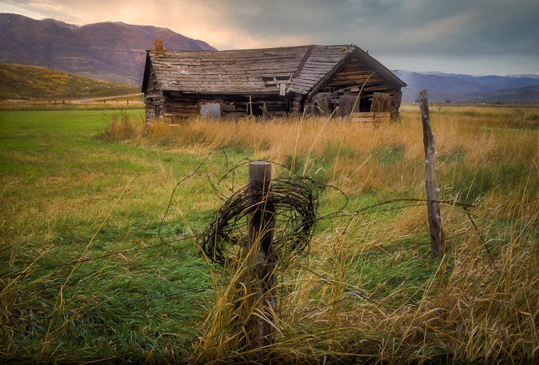 Wooden farm building in an open field