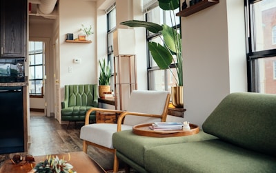 a living room with a green couch and a coffee table