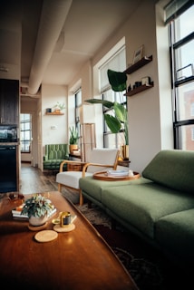 a living room with a green couch and a coffee table