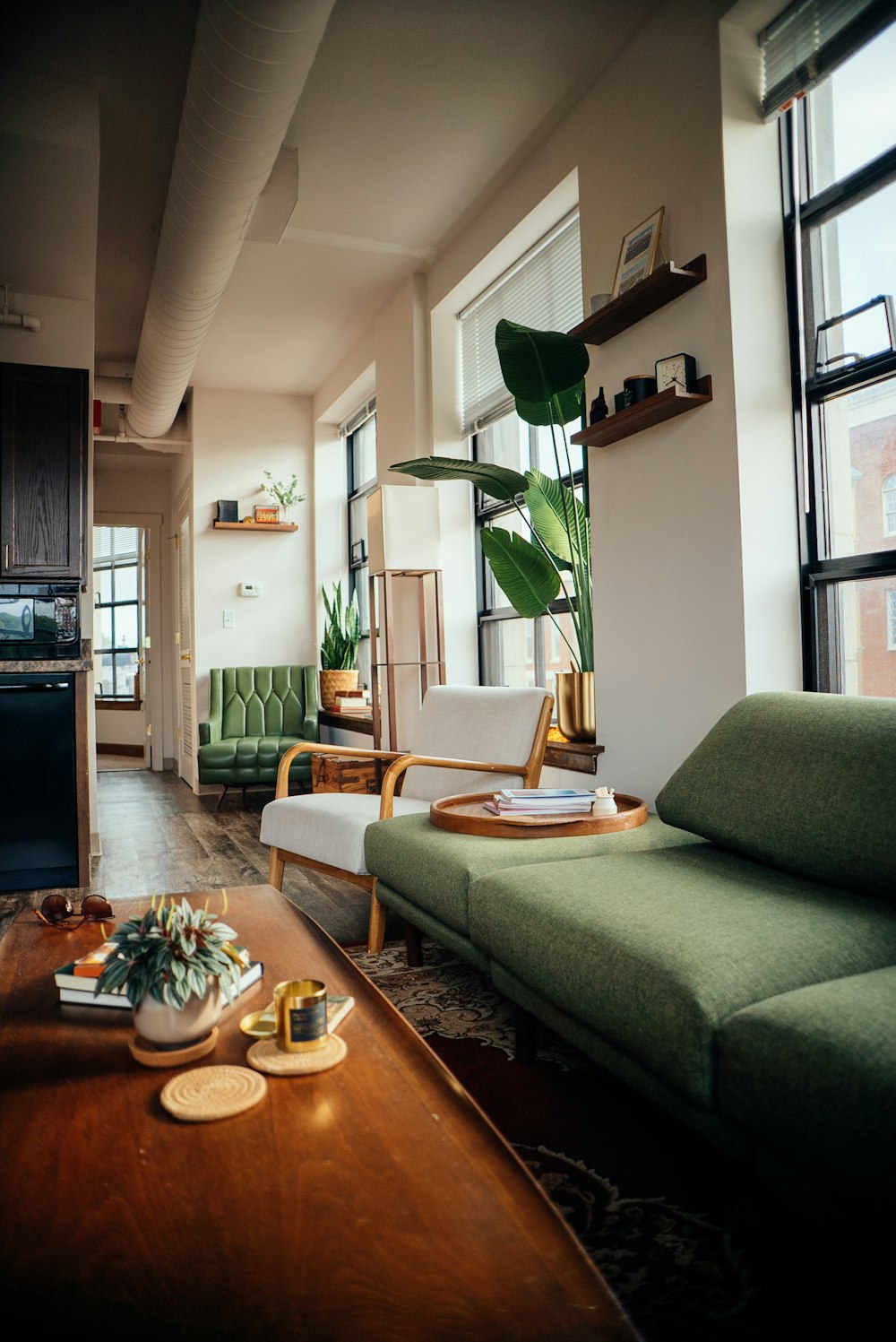 a living room with a green couch and a coffee table