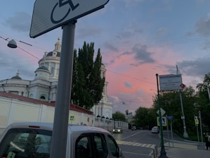 A welcoming Road to Sinai vehicle parked outside a church at sunrise.