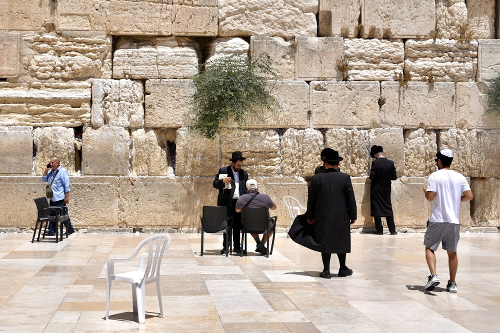 a group of people standing outside with Western Wall in the background