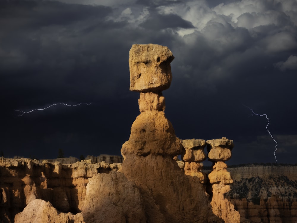 a stone statue on a rocky surface