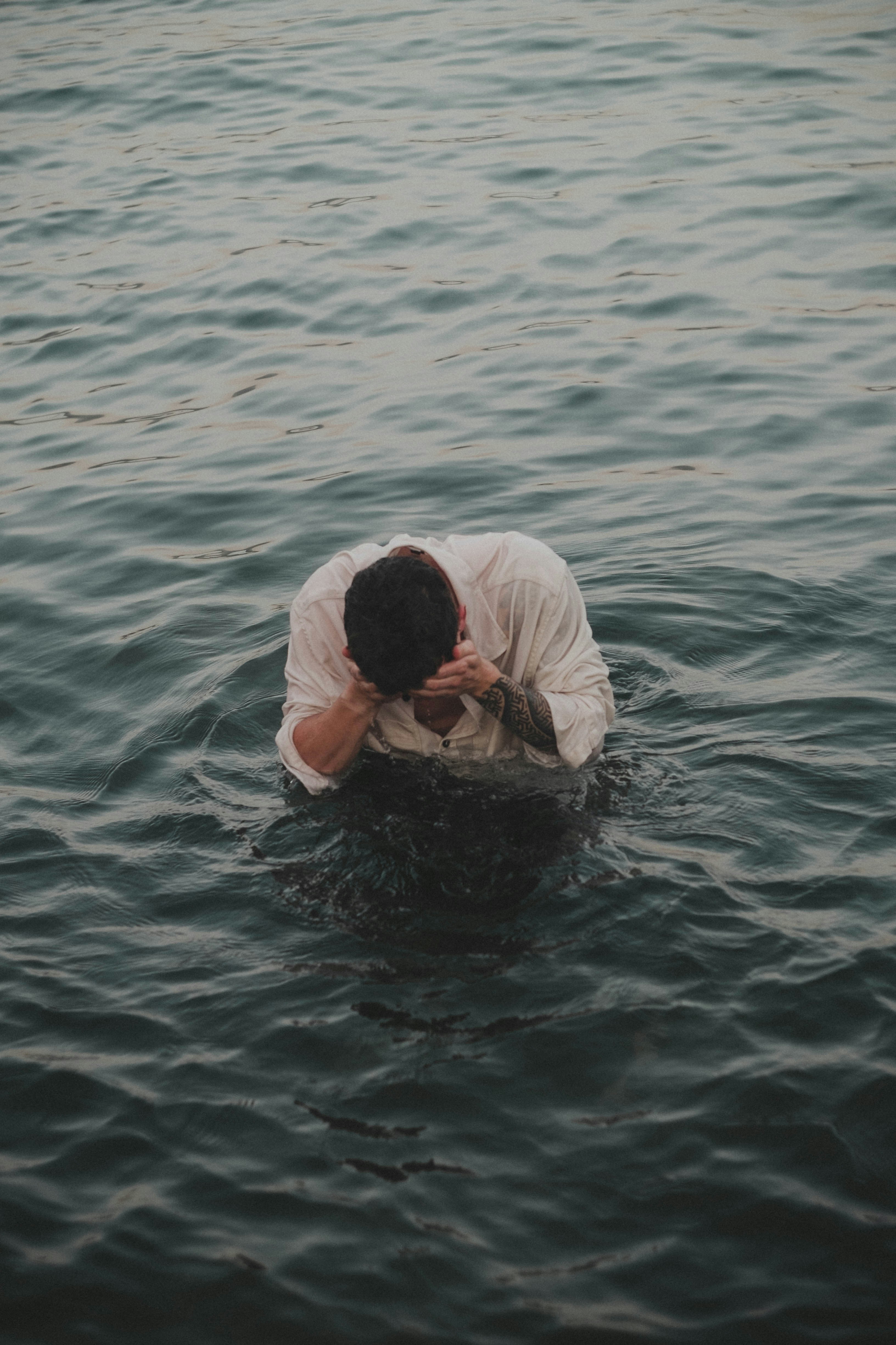 a man in a white shirt in the water