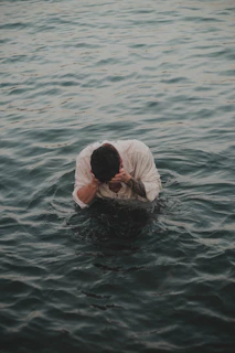 a man in a white shirt in the water
