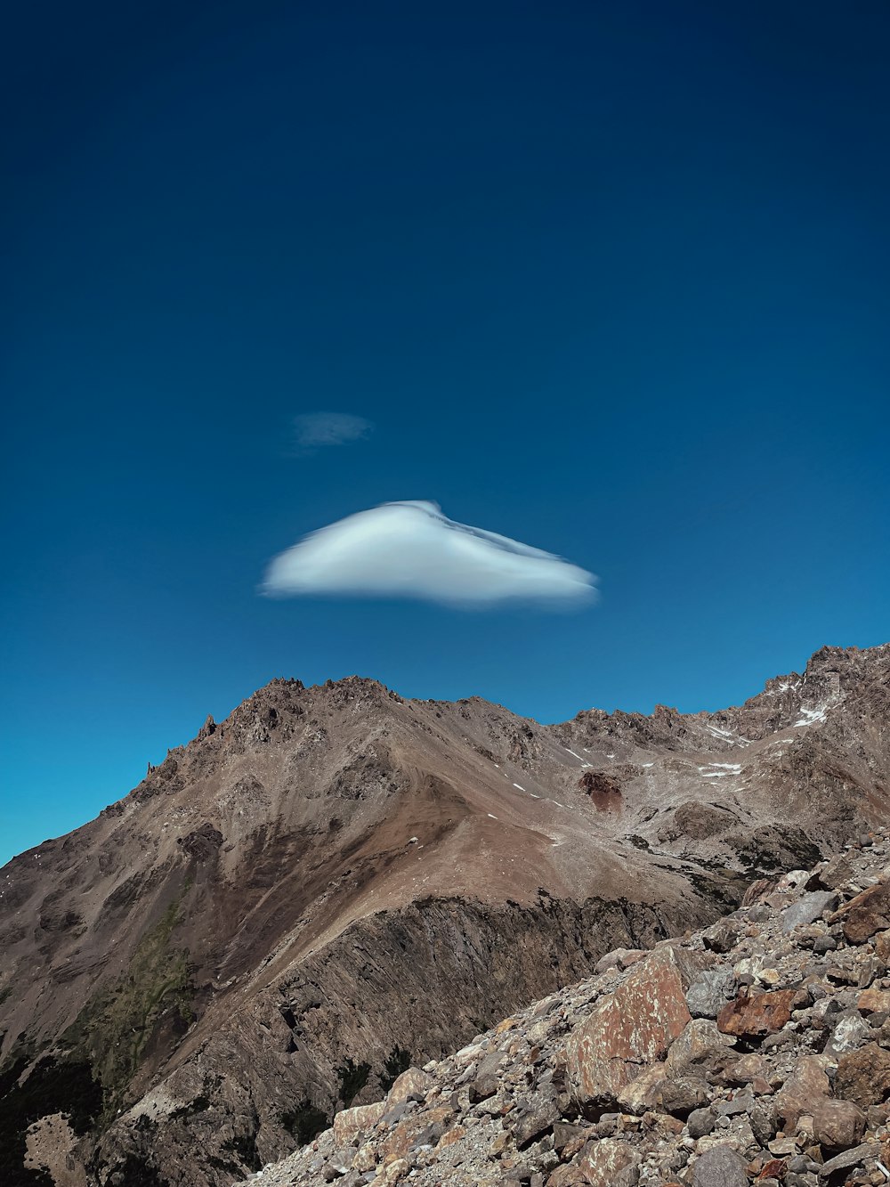 a mountain with a cloud in the sky