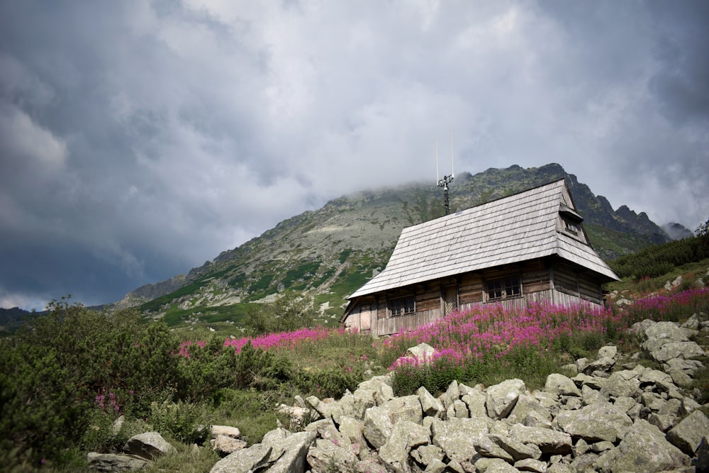 a building with a steeple and flowers in front of it