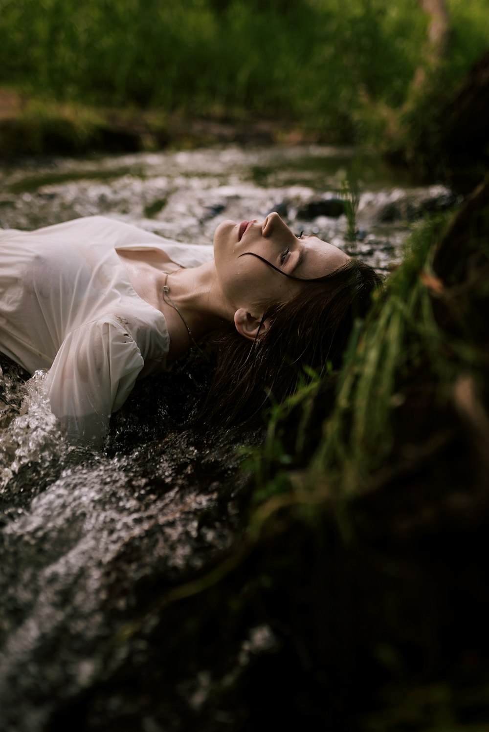 a person lying in a stream