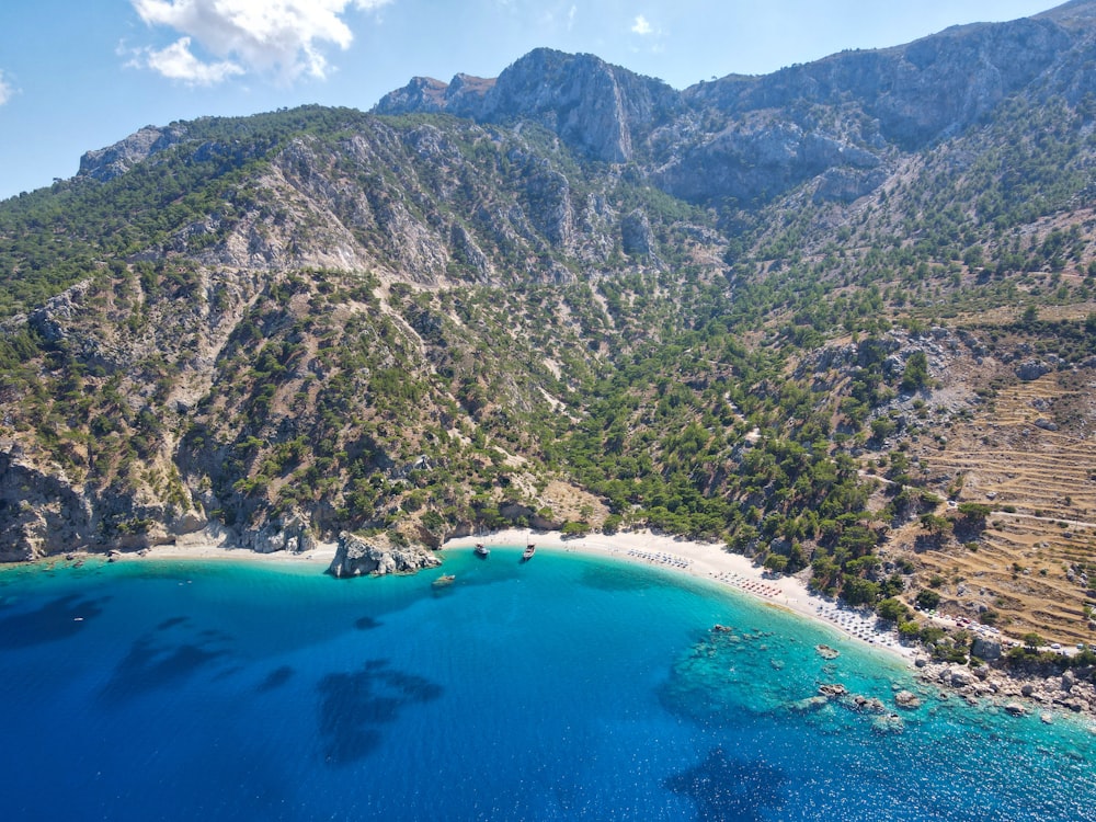 a body of water with mountains in the back