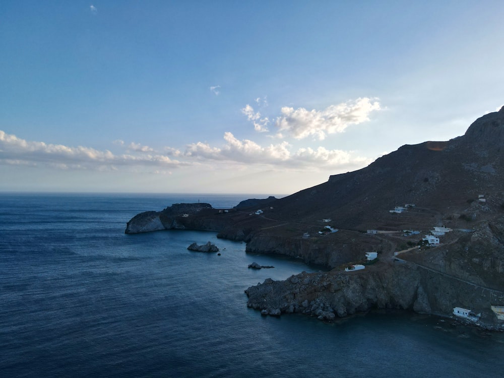 a body of water with rocks and hills around it