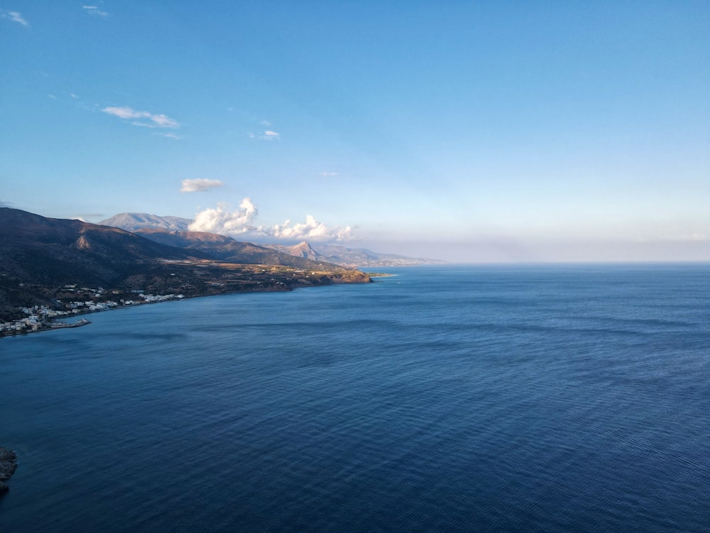 a body of water with mountains in the background