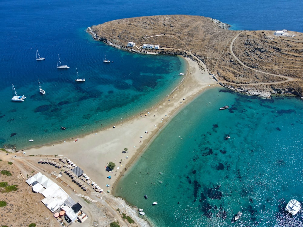 a beach with boats and buildings