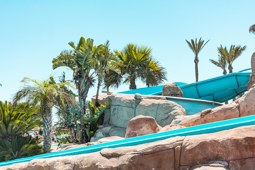 a pool with rocks and trees around it