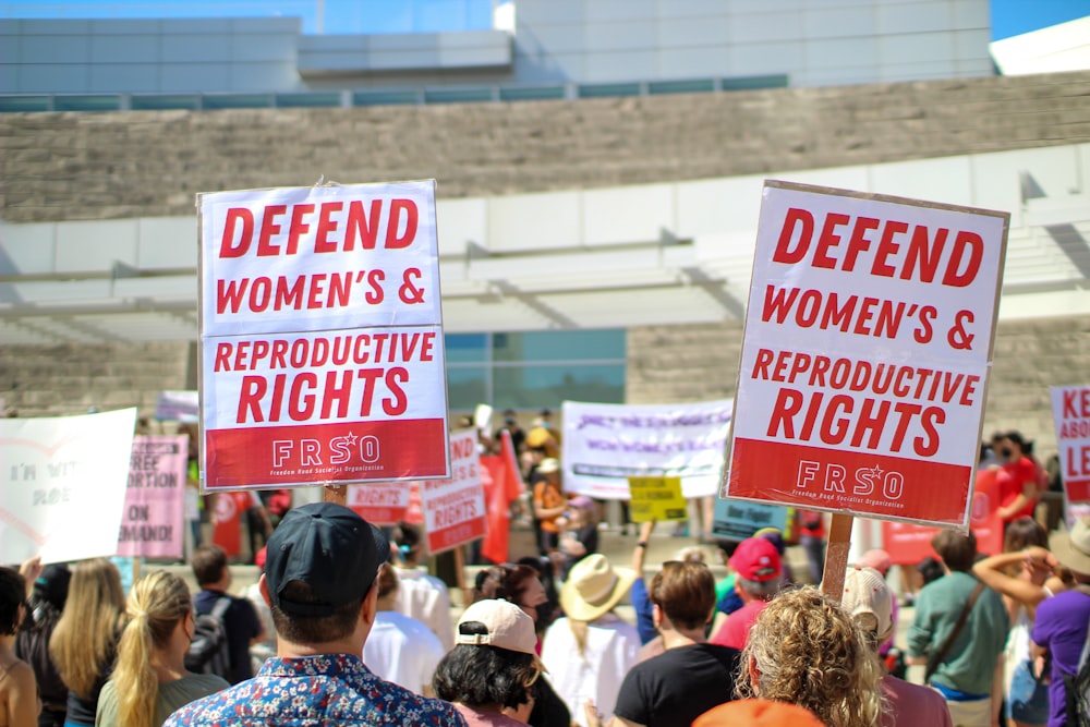 a crowd of people holding signs