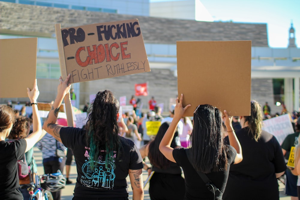 a group of people holding signs