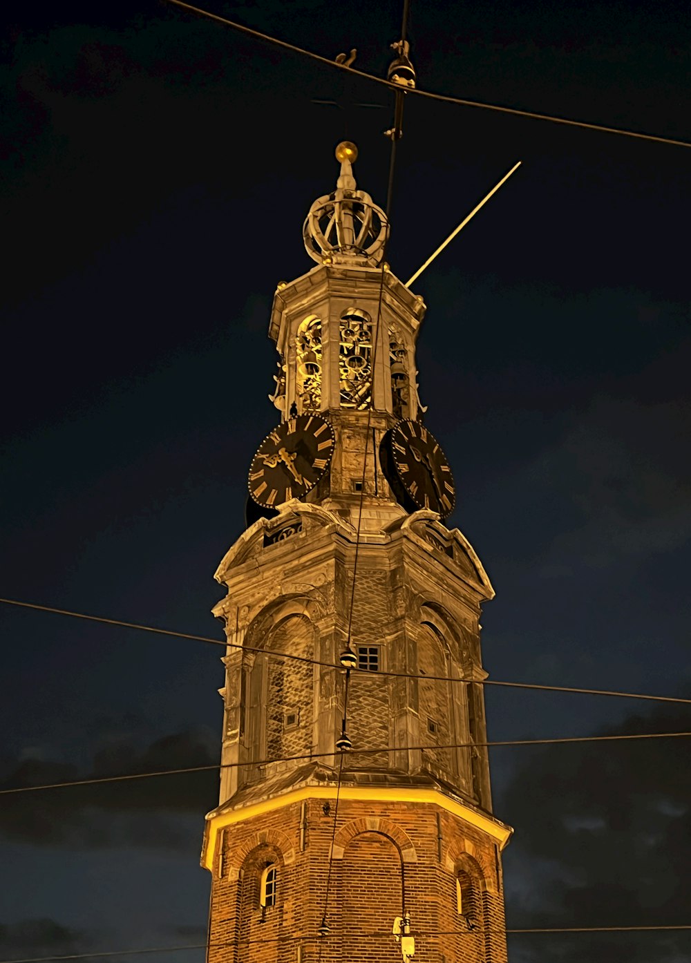 a clock tower with a weather vane with Berlin Victory Column in the background