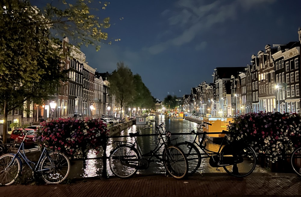 a group of bicycles parked on a bridge over a river