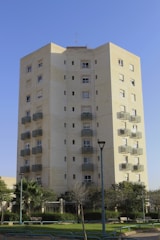 a tall building with trees in front of it