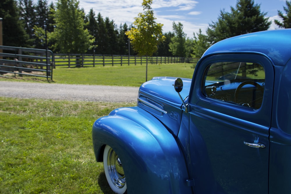 a blue car parked on grass