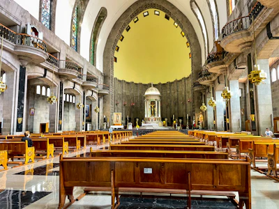 A warm and inviting modern church interior with people gathered in worship.