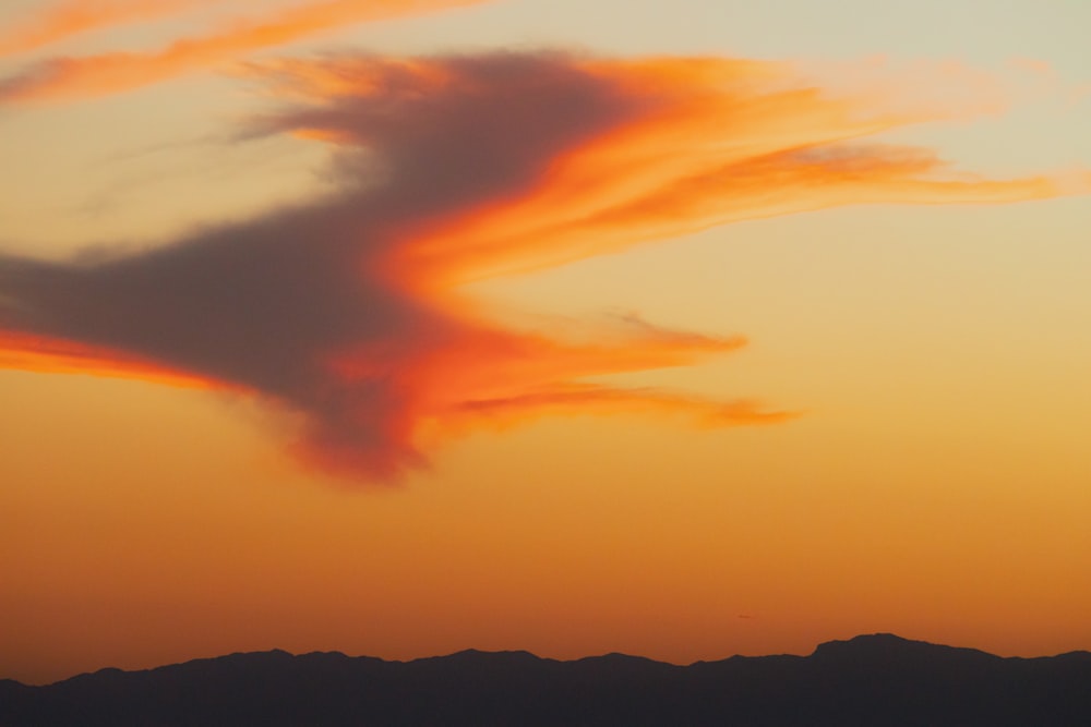 a colorful sky over mountains